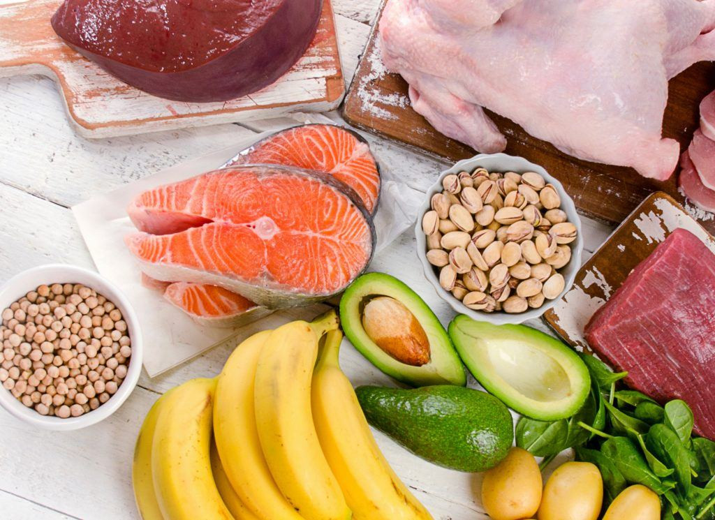 Foods naturally containing vitamin b6 such as chickpeas, poultry, bananas, dark leafy greens, salmon, tuna, and beef liver, displayed to highlight dietary sources of pyridoxine.