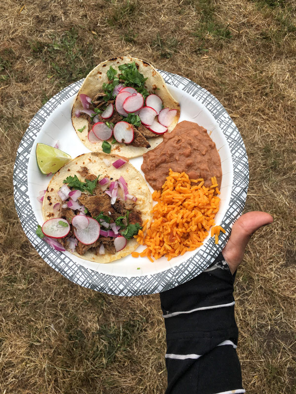 Campfire cooking with tacos and all the fixings.