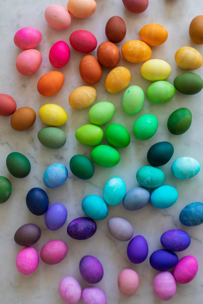 Vibrant rainbow of Easter eggs dyed with food coloring, showcasing a fun and colorful Easter tradition.