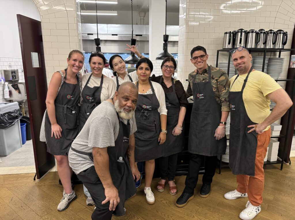 Volunteers preparing and serving free meals, showcasing community support and access to food resources.