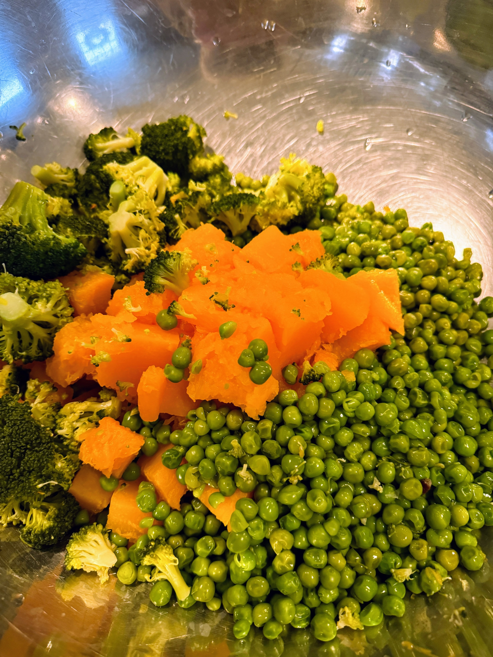 Mixing peas, broccoli, and pumpkin for a nutritious dog food recipe.