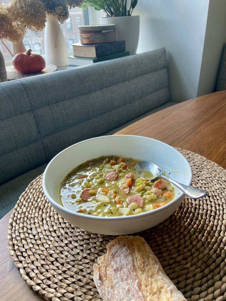 Open cookbook displaying a recipe for German pea stew with sausage.