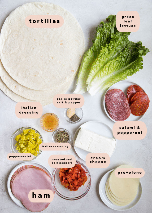 Ingredients for Italian pinwheels arranged on small white plates.