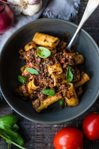 Hearty lentil bolognese in a white bowl.