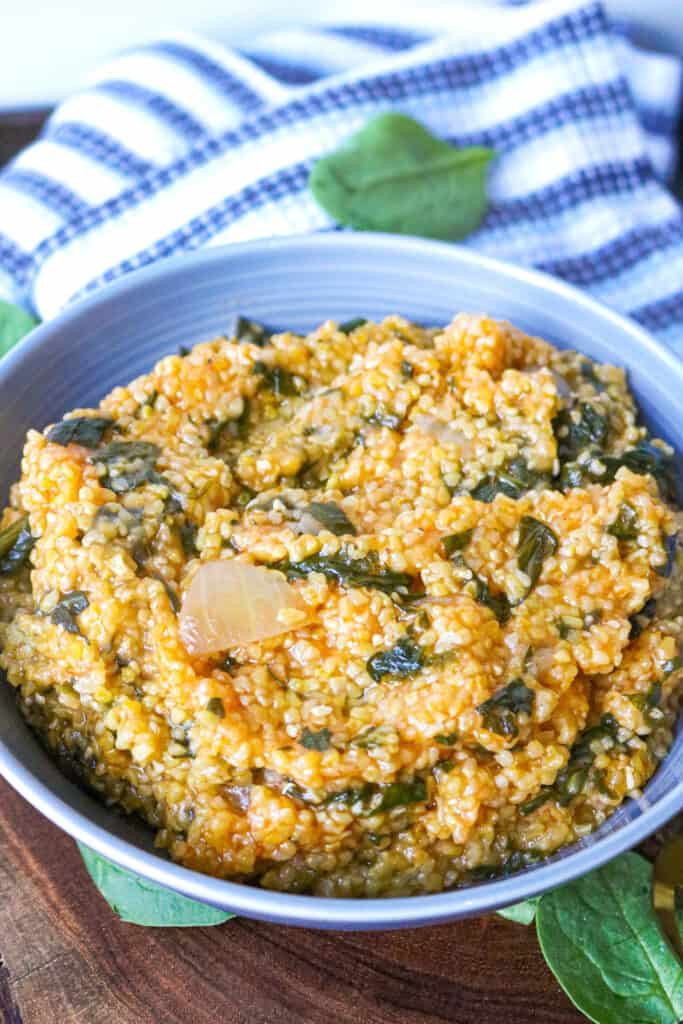 Mais Moulin, a creamy Haitian cornmeal dish with spinach, demonstrating a savory food that begins with Y made with yellow cornmeal.