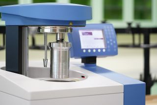 Bomb calorimeter device used in food science laboratories to accurately measure calorie content in food for nutritional information.