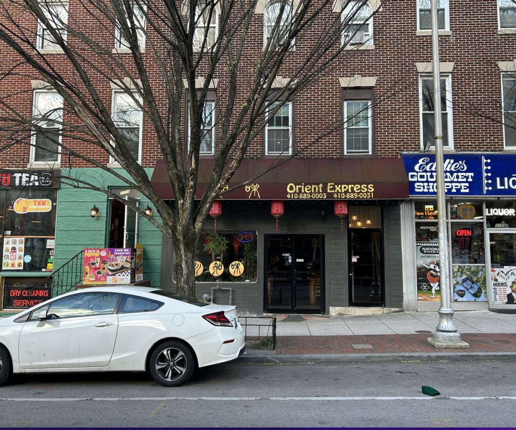 Exterior view of Orient Express restaurant on St. Paul Street in Baltimore, showcasing its signage and traditional Chinese architectural style.