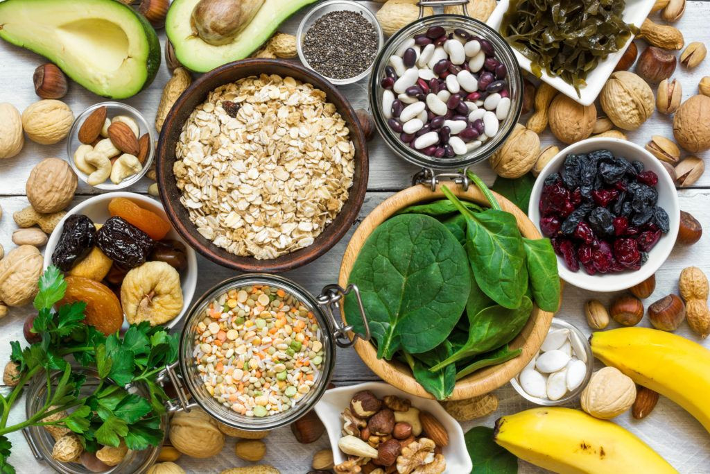 Variety of magnesium rich foods including nuts, seeds, legumes, and dark leafy greens