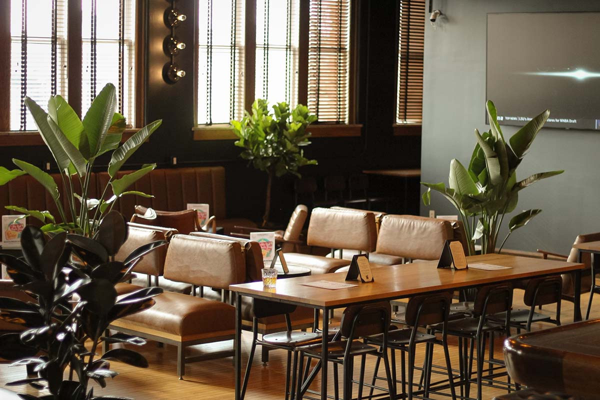 Simon's Bar at Budd Dairy Food Hall with leather seating and a wooden bar.