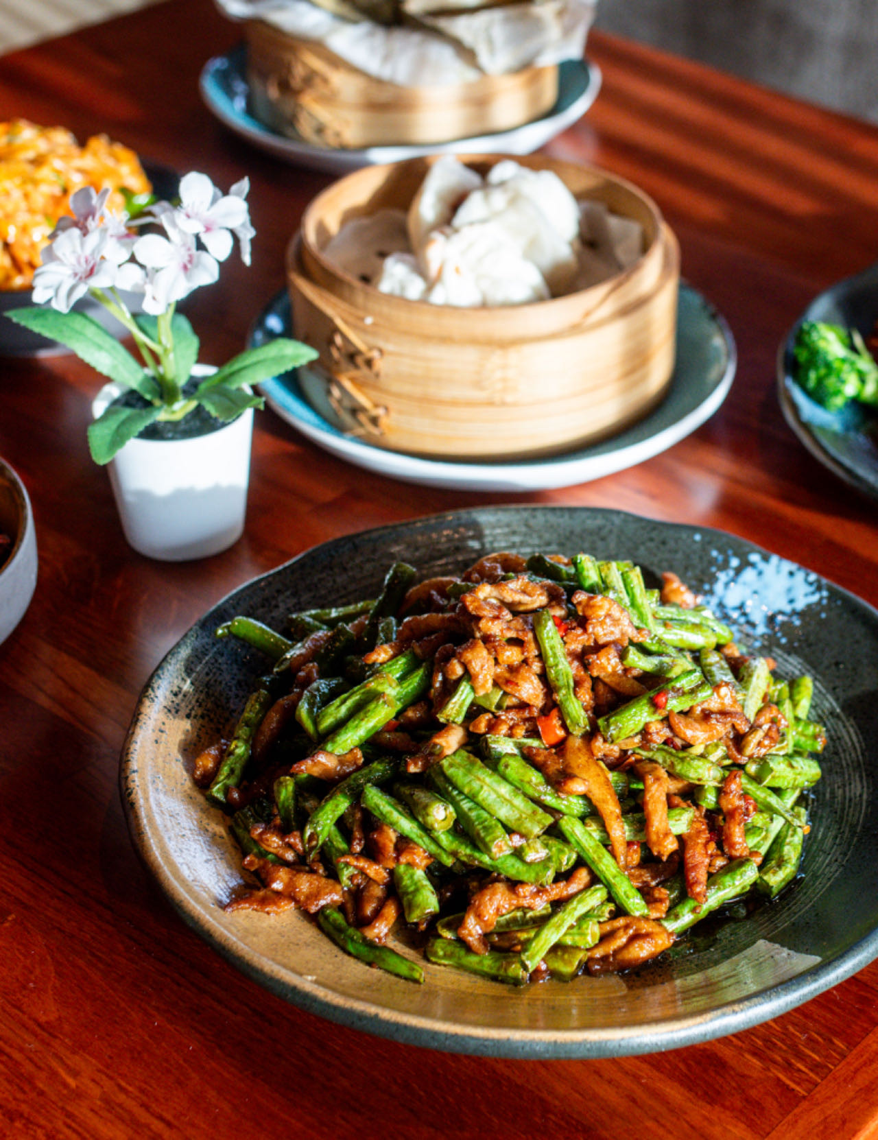 A table filled with various Chinese dishes at Peter Chang restaurant in Gaithersburg.