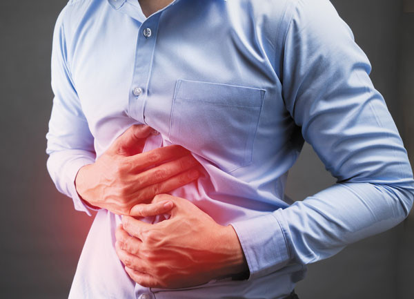 A person experiencing stomach discomfort, indicative of diarrhea.