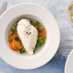 Poached chicken breast in a bowl with vegetables