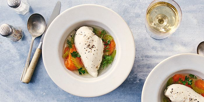 Poached chicken breast in a bowl with vegetables