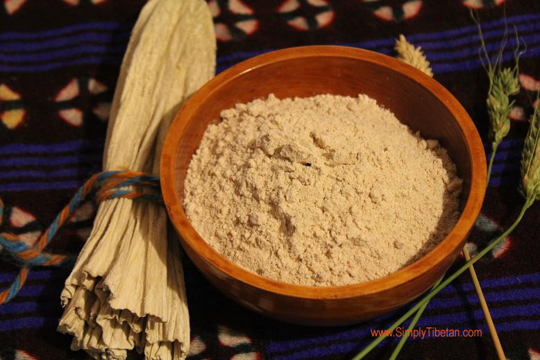 alt text: A bowl of Tsampa, a staple in Tibetan cuisine made from roasted barley flour.