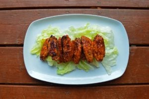 alt text: A plate of classic Buffalo wings with celery sticks and blue cheese dressing.