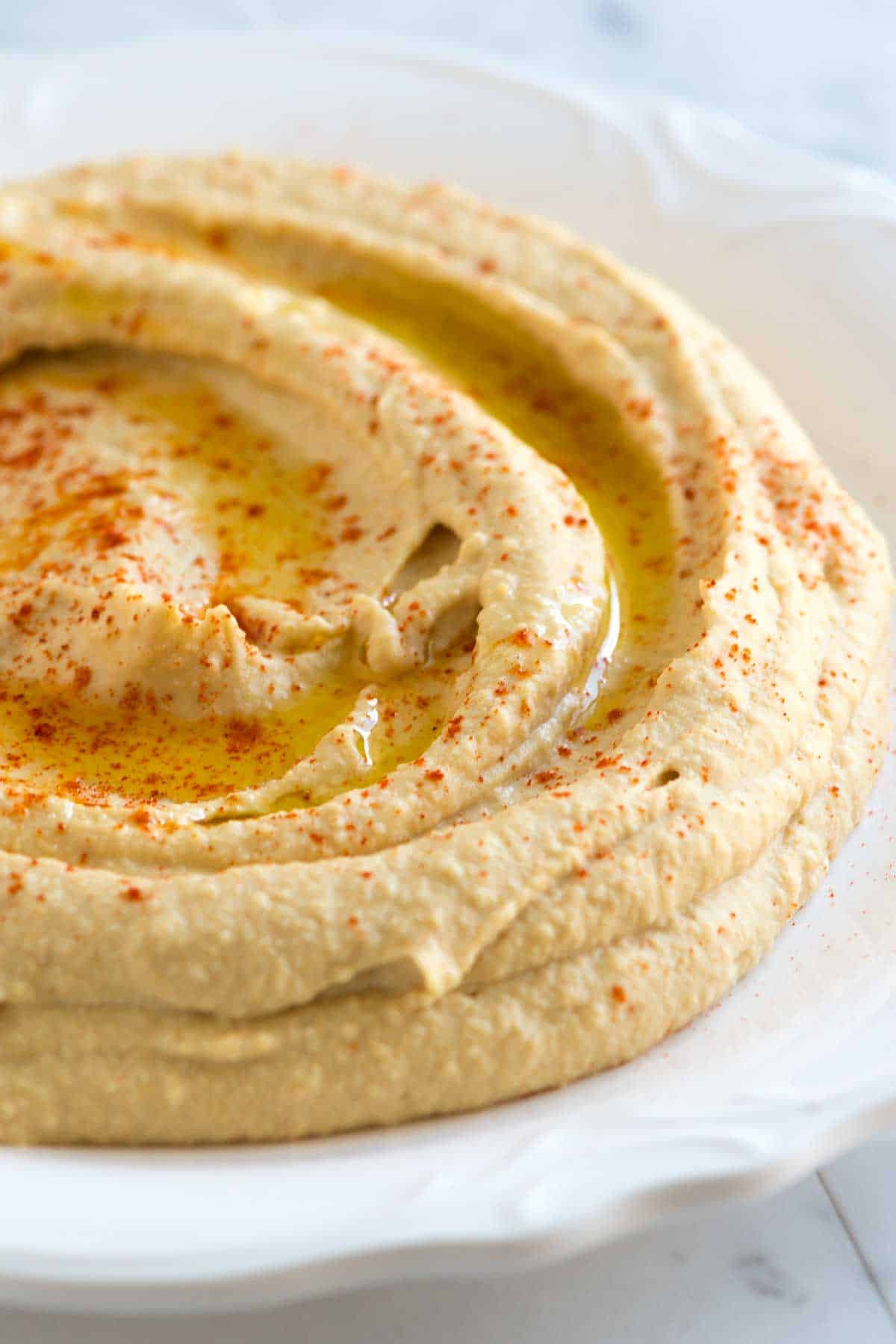 Ingredients for making hummus: chickpeas, tahini, lemon juice, garlic, olive oil, and spices.
