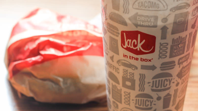 A wrapped sandwich and a drink from Jack in the Box