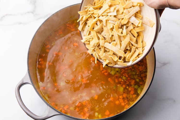 Adding homemade egg noodles to the broth
