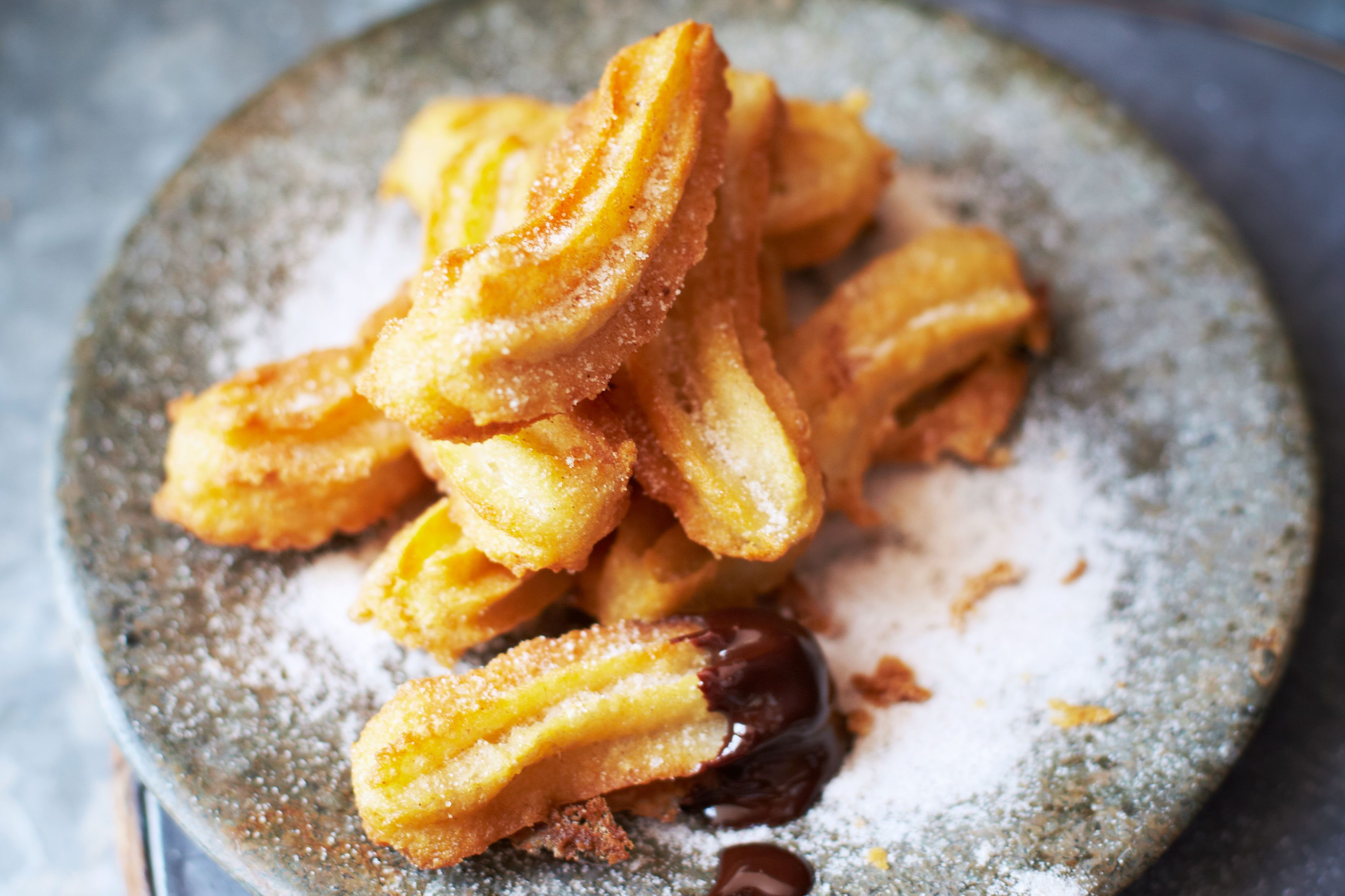 Churros offer a Spanish-style fried dough treat with a rich chocolate dipping sauce, perfect for larger Hanukkah gatherings and easy to make with baking powder.