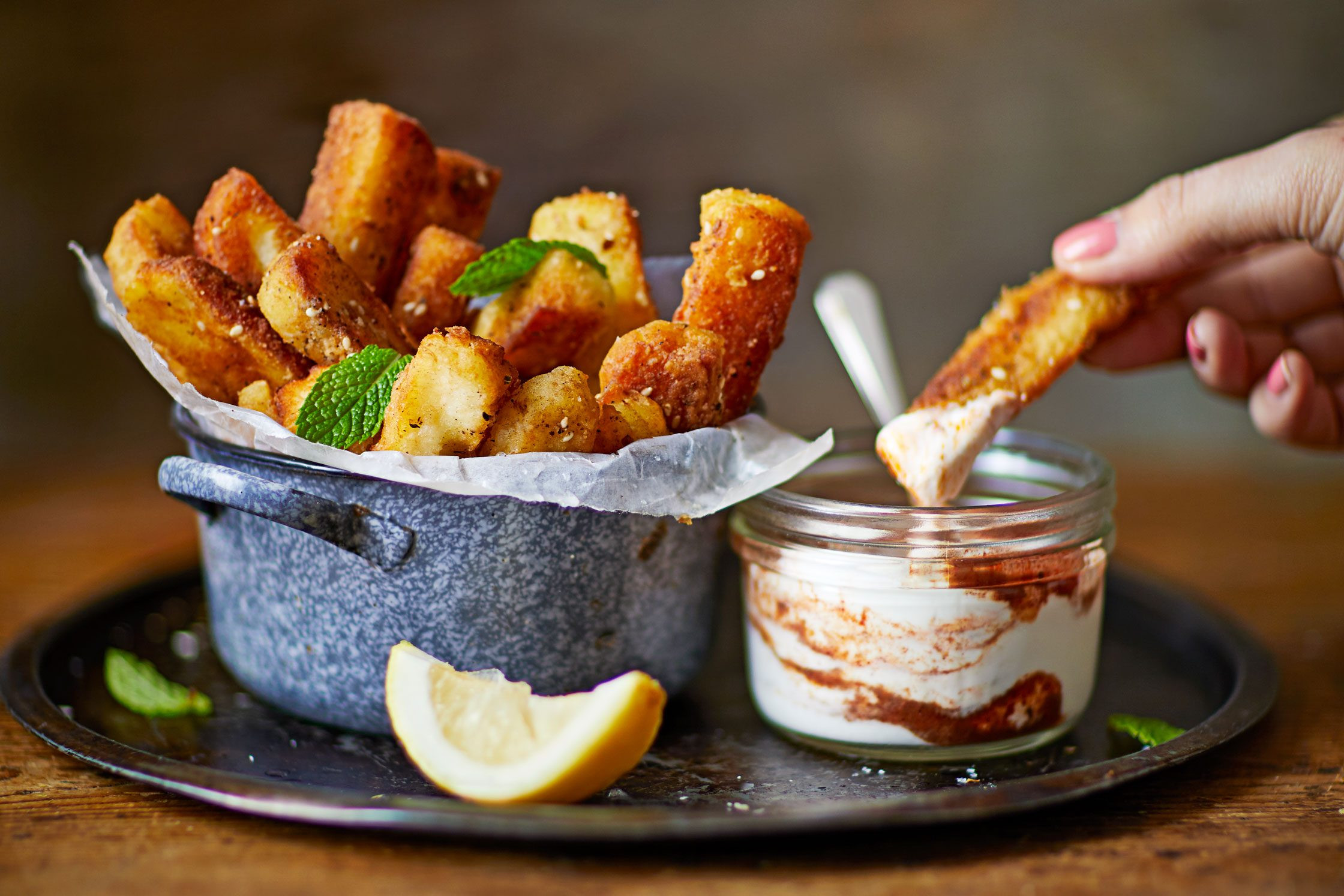 Halloumi fries are a crunchy, spiced cheese snack perfect for Hanukkah parties, especially when paired with za'atar and a tangy dipping sauce.