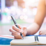 Woman writing in a food journal
