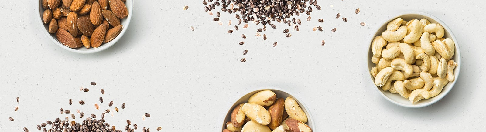 Assortment of nuts and seeds in wooden bowls