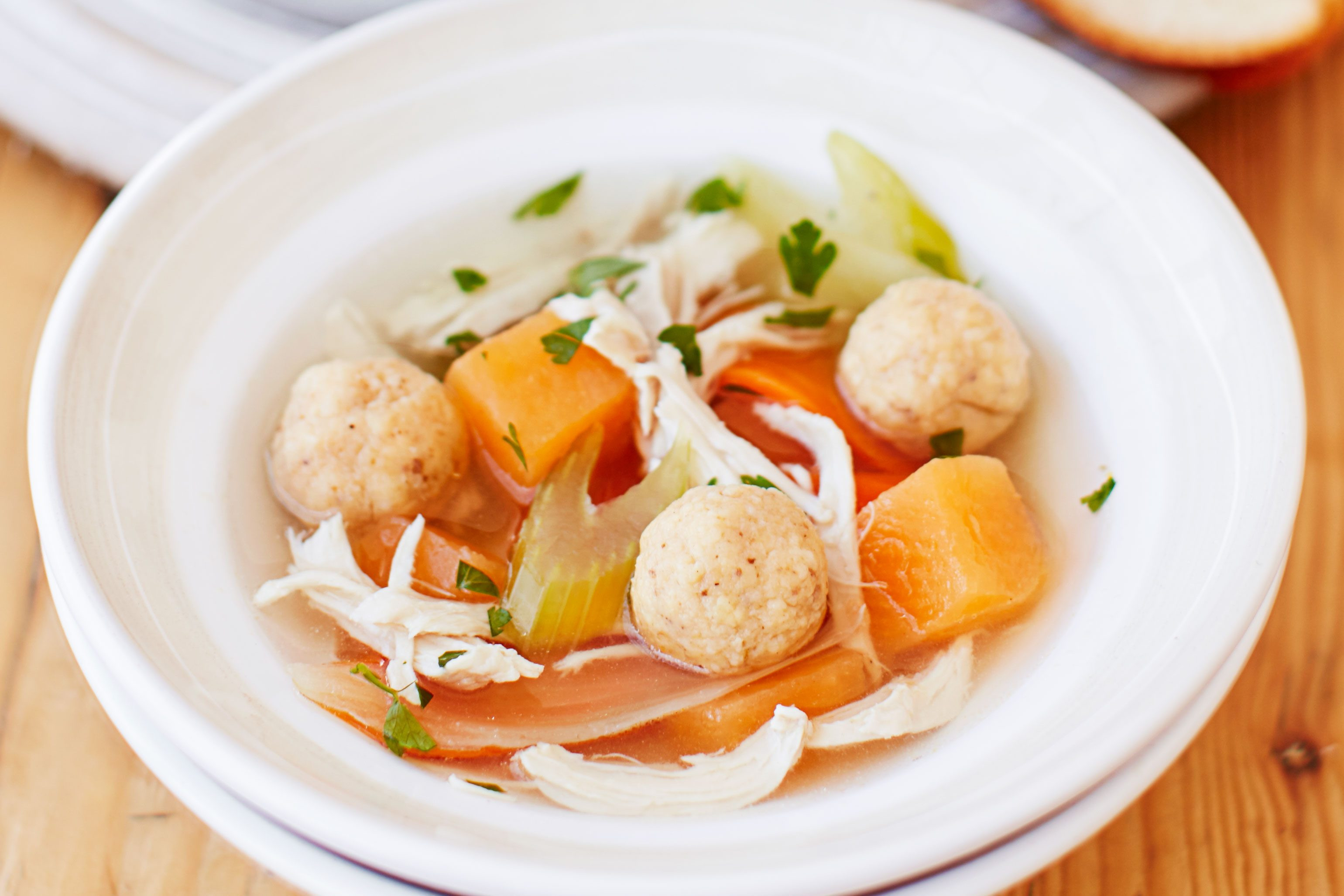 Chicken matzo ball soup, known as Jewish penicillin, offers a comforting and nutritious option during Hanukkah, perfect for balancing out heavier fried foods.