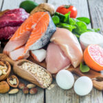 Chicken and rice ingredients displayed on a wooden table.