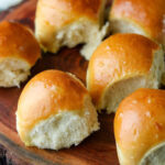 Close-up of milk bread rolls on a wooden cutting board