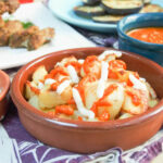 Patatas bravas with spicy tomato sauce and aioli, showcasing a classic Spanish tapas dish.