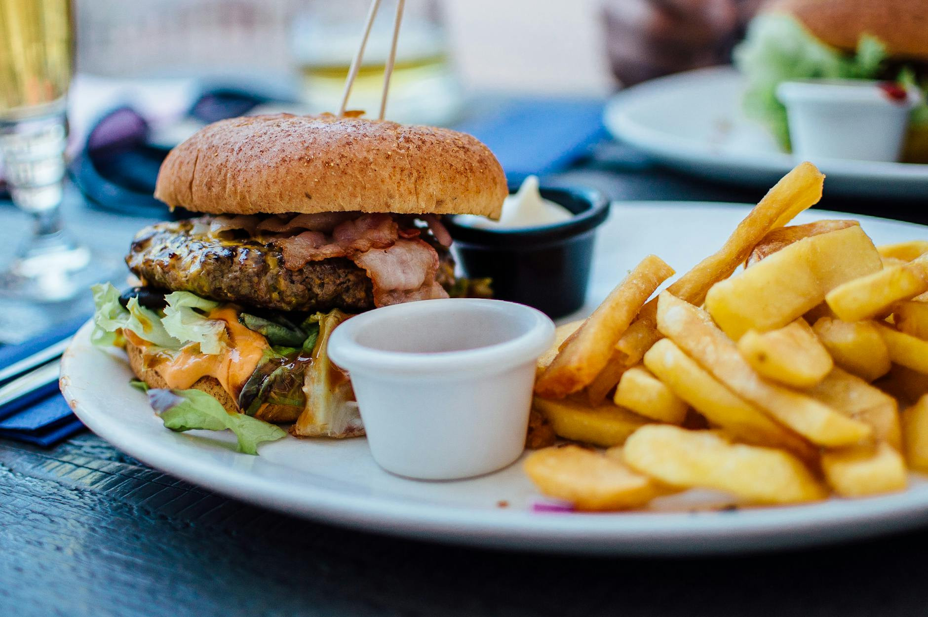A futuristic fast food restaurant with automated service and healthy, plant-based menu options, showcasing trends and innovations in the industry