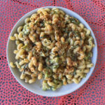 Plate of macaroni and cheese on a red table