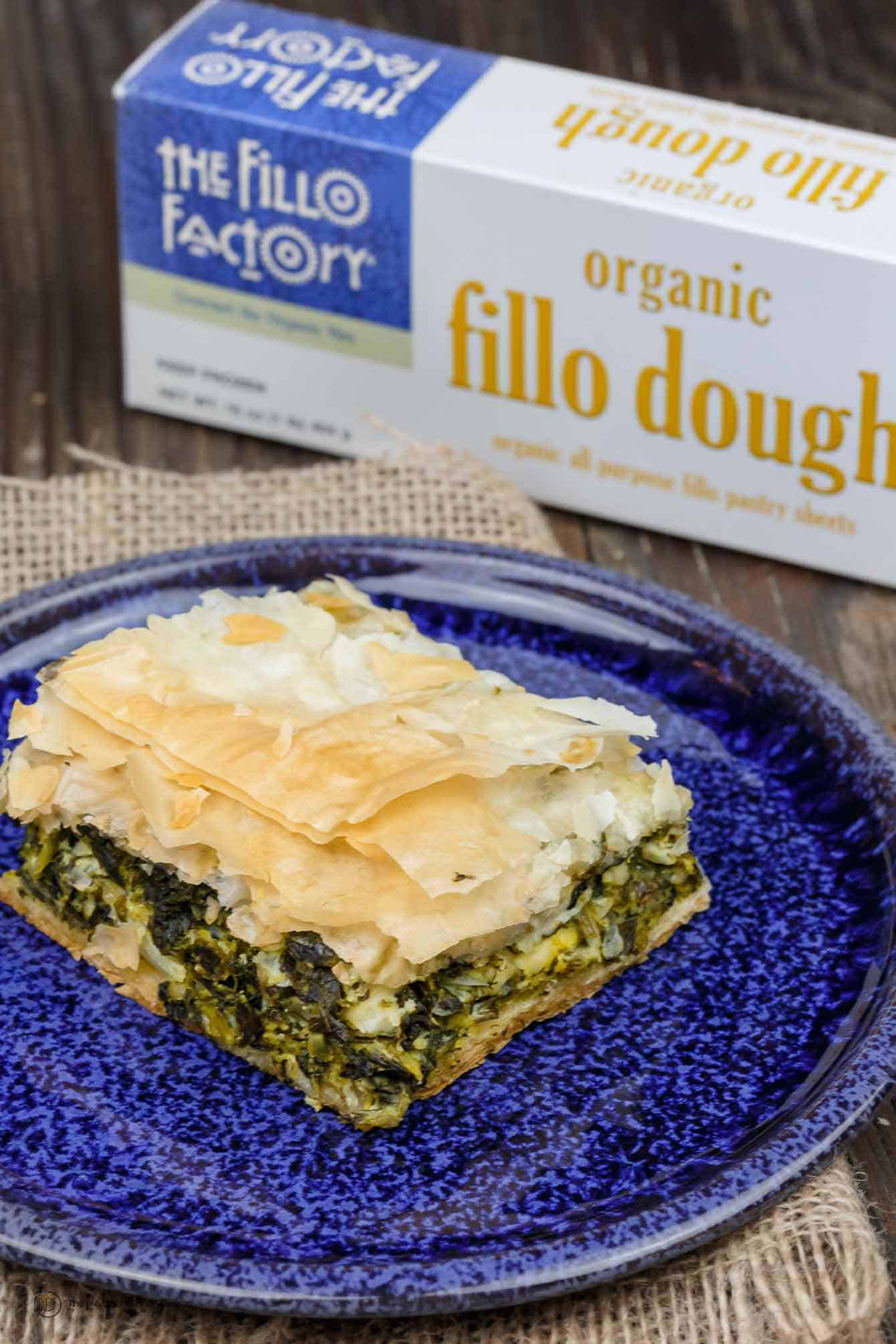 A slice of traditional Spanakopita showcasing flaky phyllo layers and spinach filling