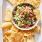 Loaded Guacamole with bacon, sun-dried tomatoes, and cotija cheese